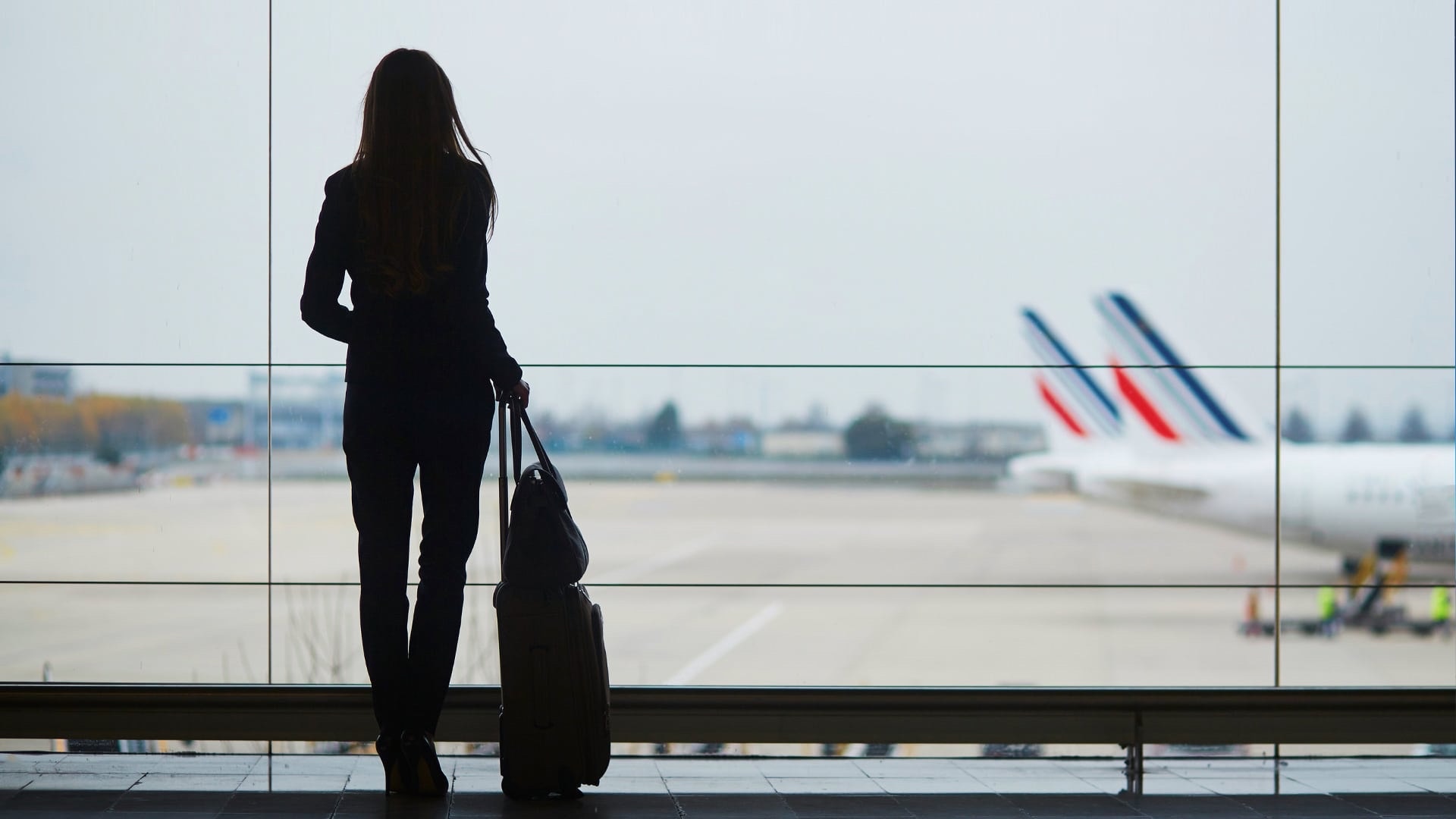 Traveler observing the runway at an airport